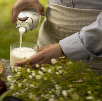 high angle hand pouring milk cupgggg_338x337