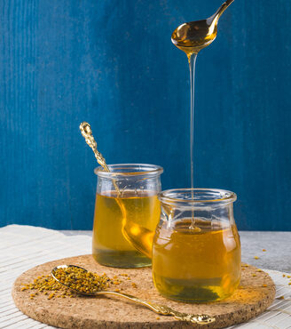 honey dripping from spoon pot bee pollens cork coaster_328x459 e1714995795382